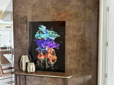 A painting is hanging on a wall next to a table.