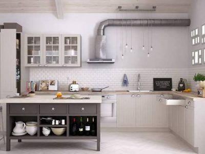 A kitchen with white cabinets and a large island in the middle.