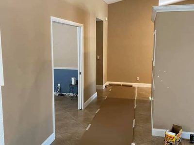 A hallway in a house that is being painted.