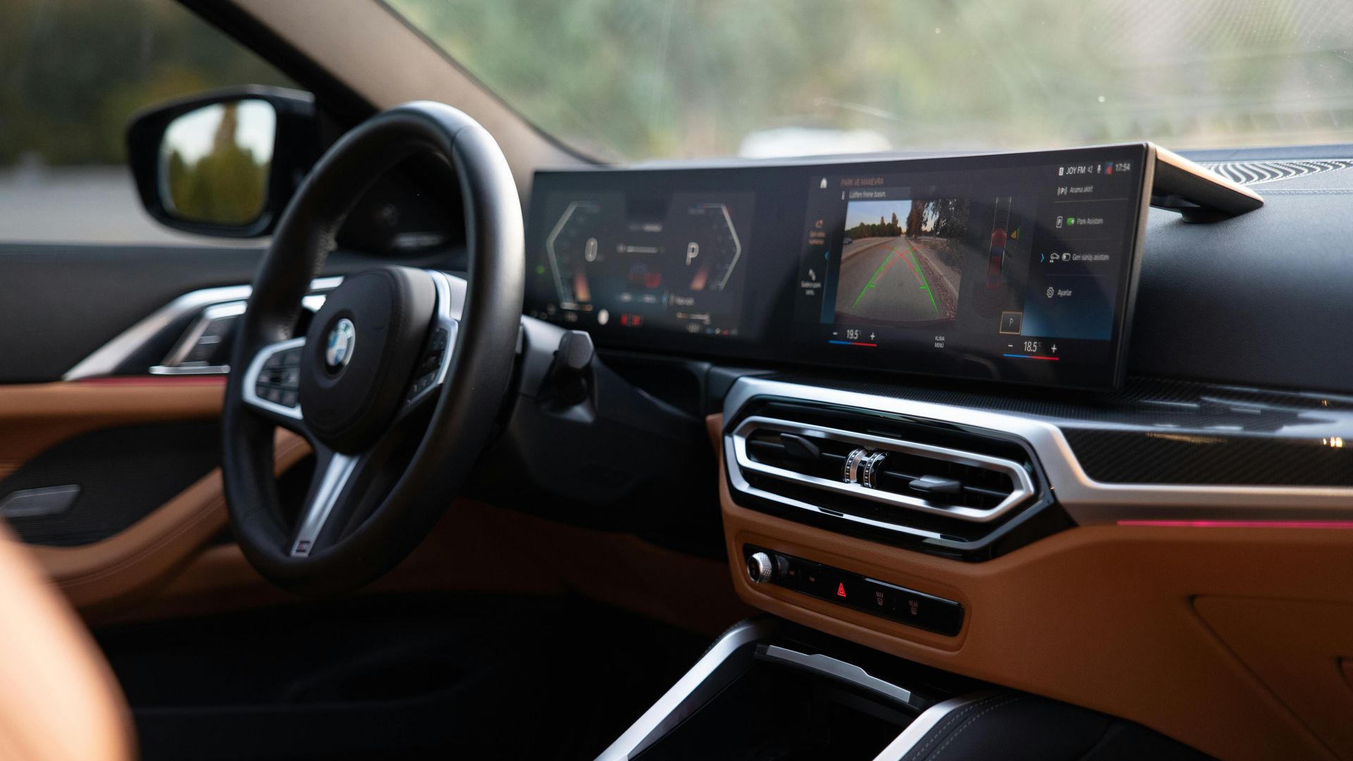 The interior of a car with a steering wheel and dashboard.