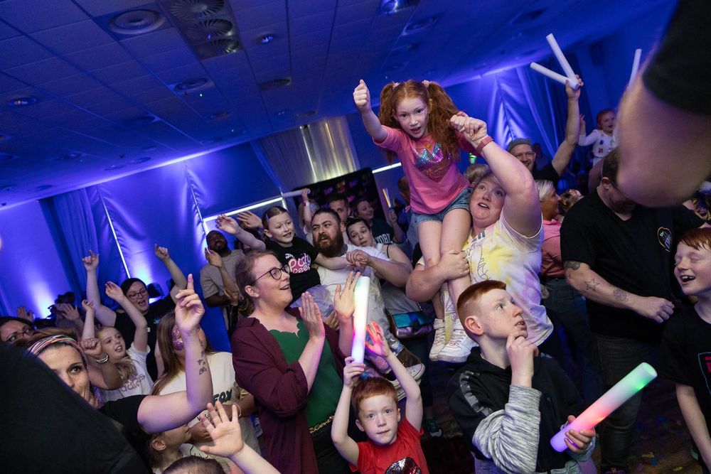 A crowd of people are dancing in front of a stage Warrandyte