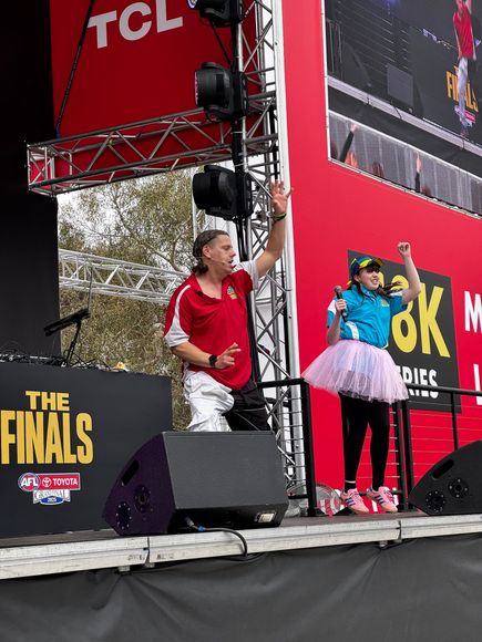 A crowd of people are dancing in front of a stage Balwyn