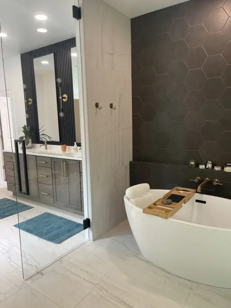 A bathroom with a tub , sink and mirror.