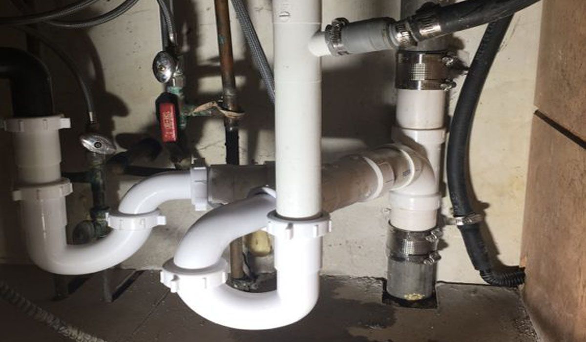 drain pipes under a kitchen sink