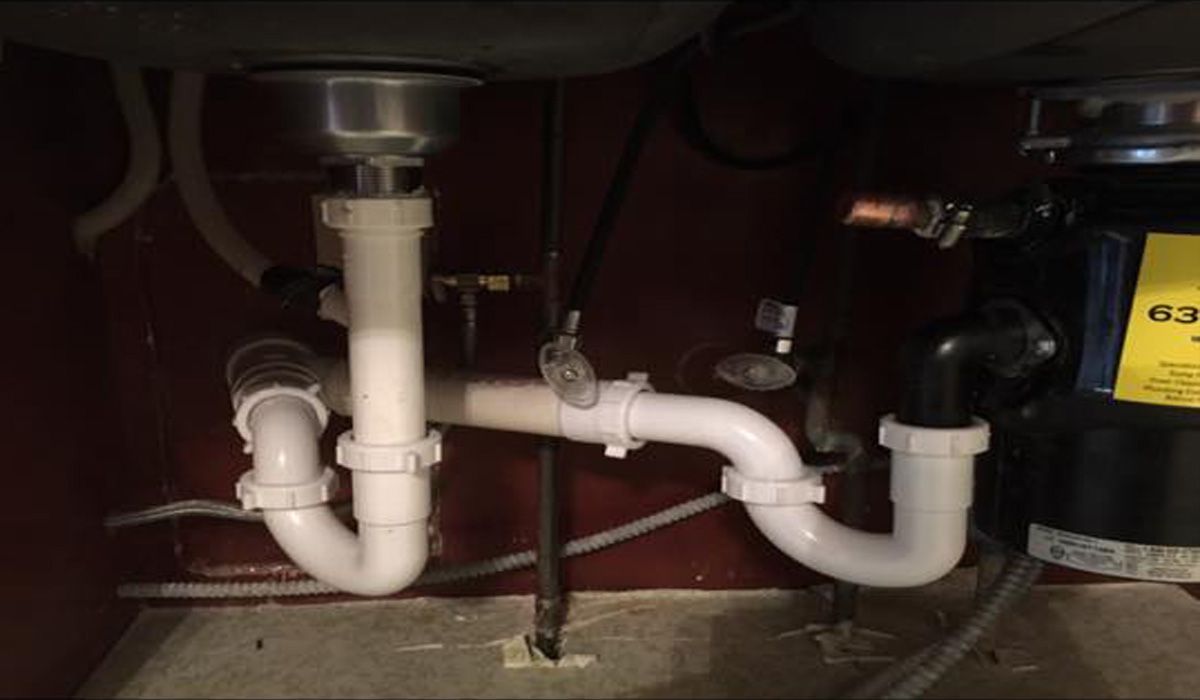 Home's Plumbing: drain pipes under a kitchen sink