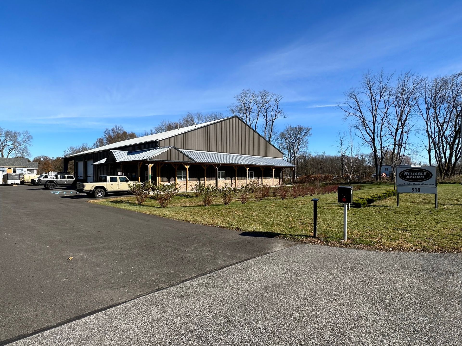 A building with a large archway and sliding glass doors.