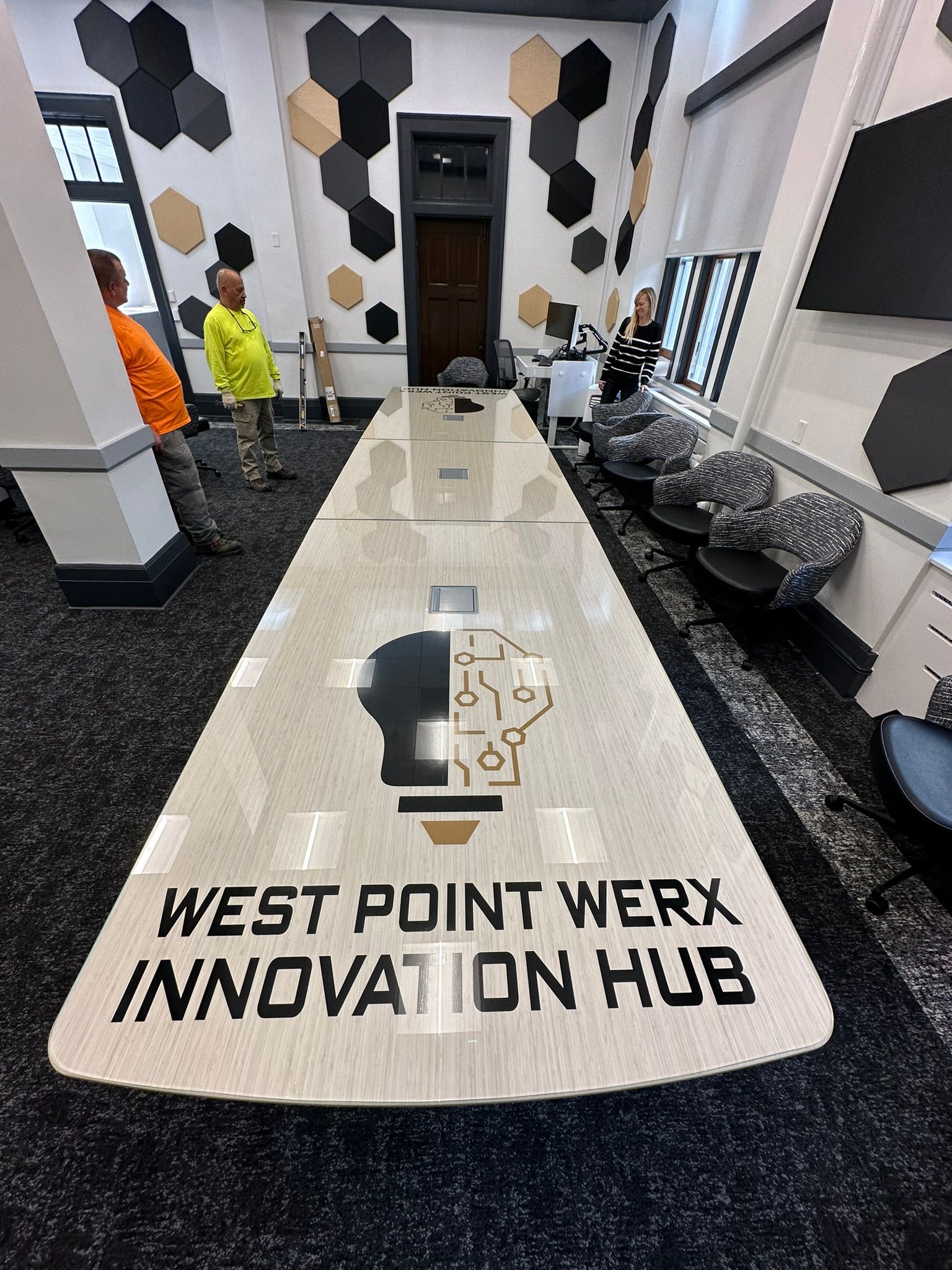 A long table with the words west point werf innovation hub on it.