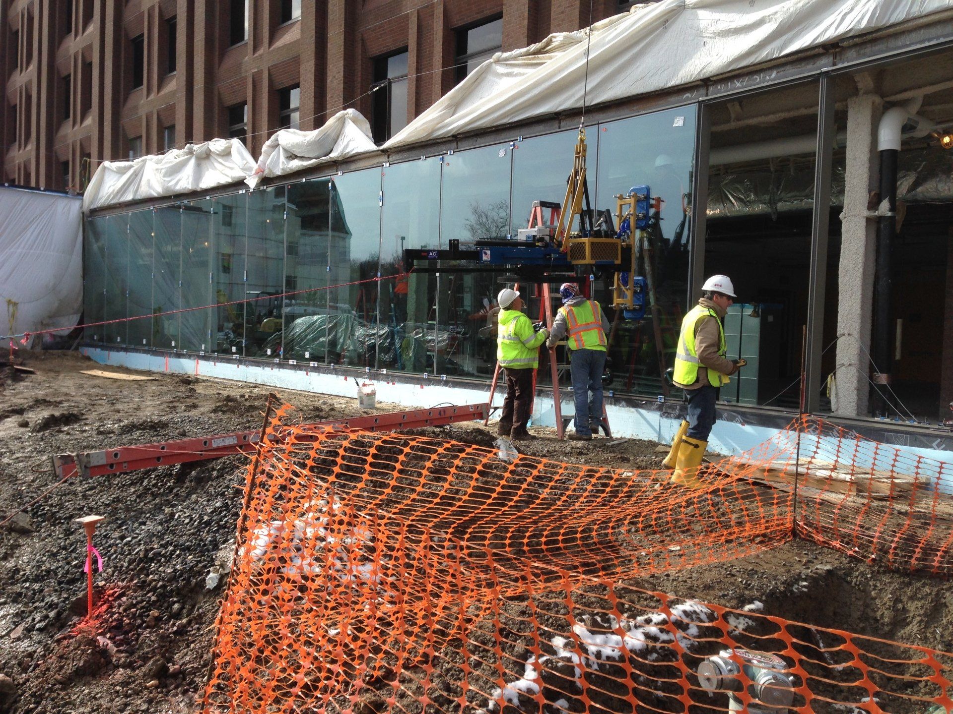 A group of construction workers are standing in front of a building.