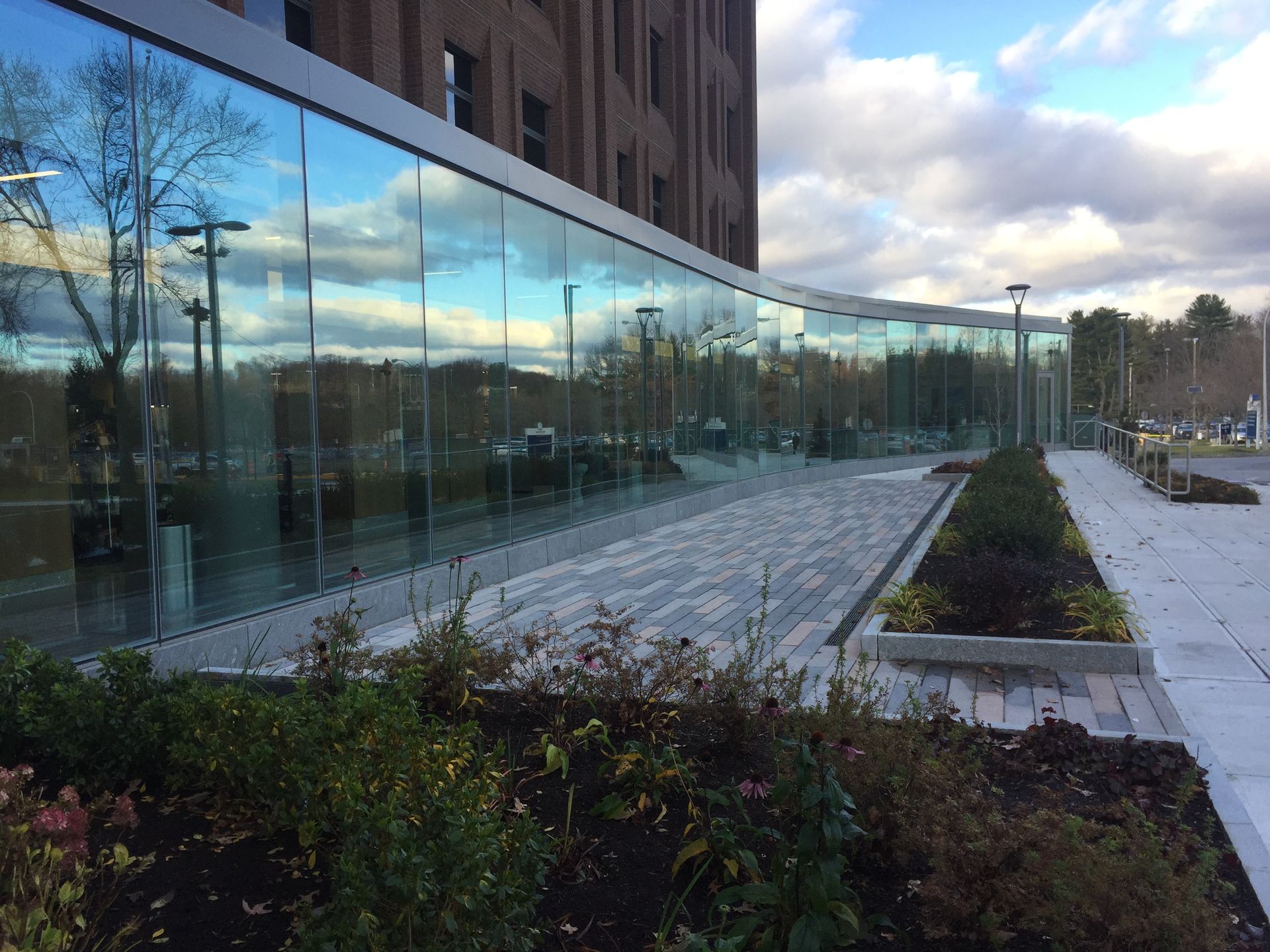 A building with a lot of windows and a patio in front of it.
