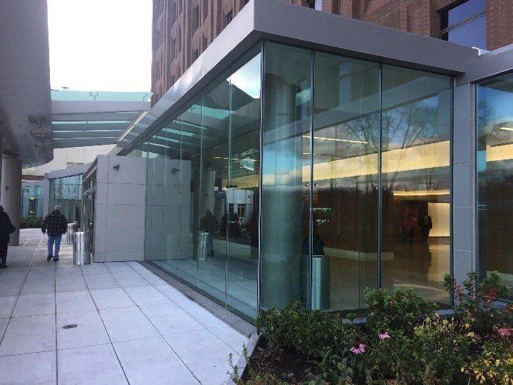A brick building with stairs leading up to the front door.
