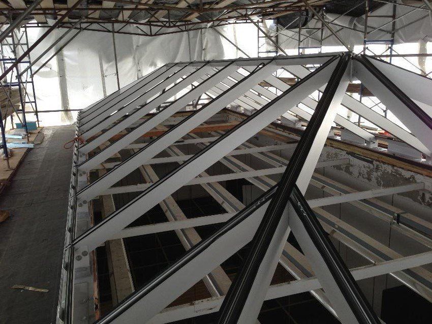 The roof of a building under construction with scaffolding around it