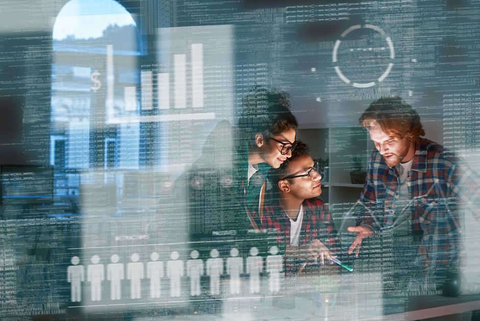 Three people collaborating at a desk, looking at data visualizations overlaid on window reflections.