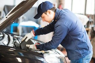 Mechanic changing oil in a car engine - repair in Worcester, MA