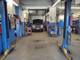 Mechanic examining car engine - repair in Worcester, MA