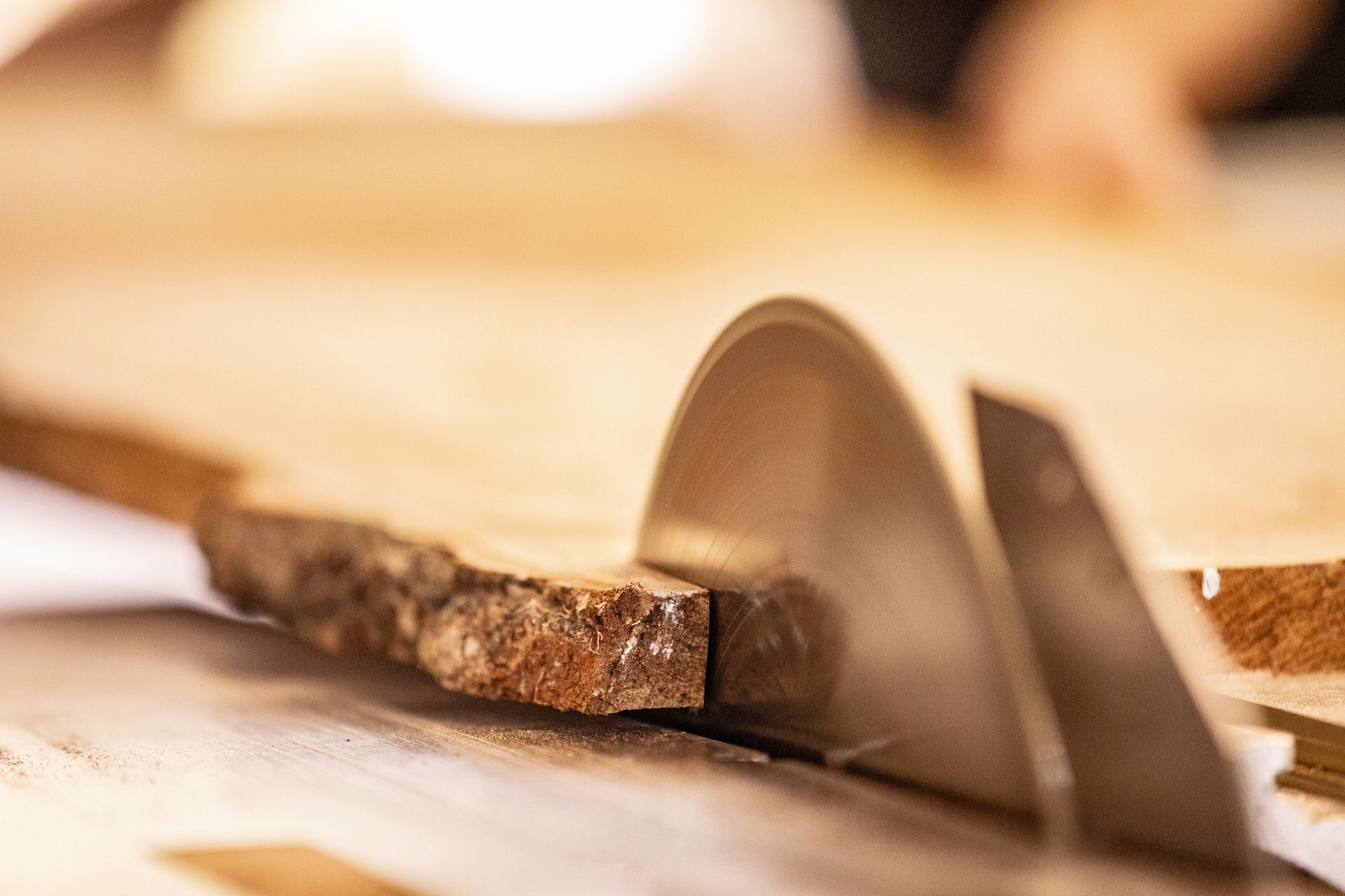 A person is cutting a piece of wood with a circular saw.