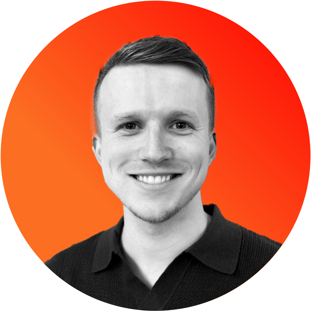A man in a black shirt is smiling in an orange circle