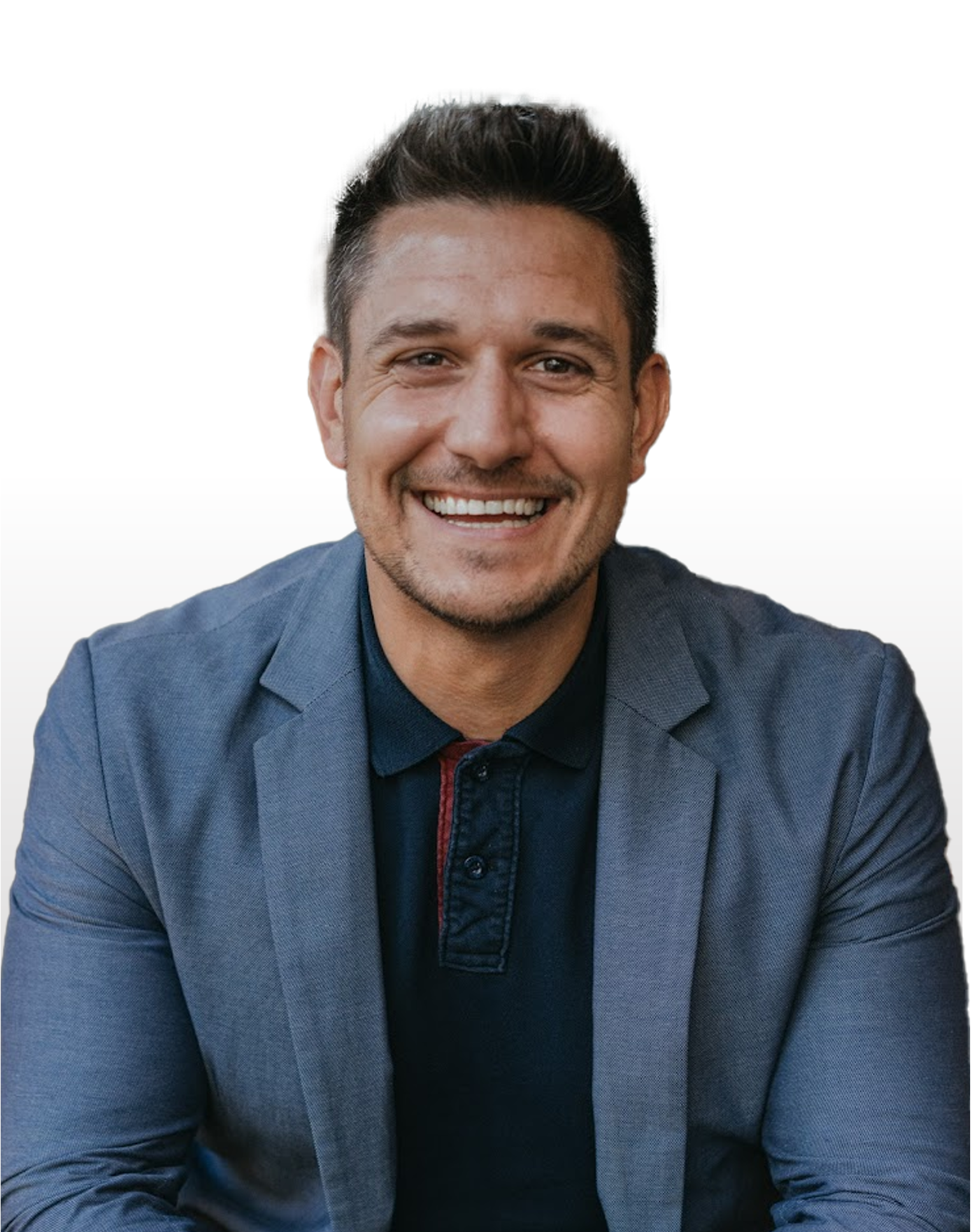 A man in a suit and polo shirt is smiling for the camera.