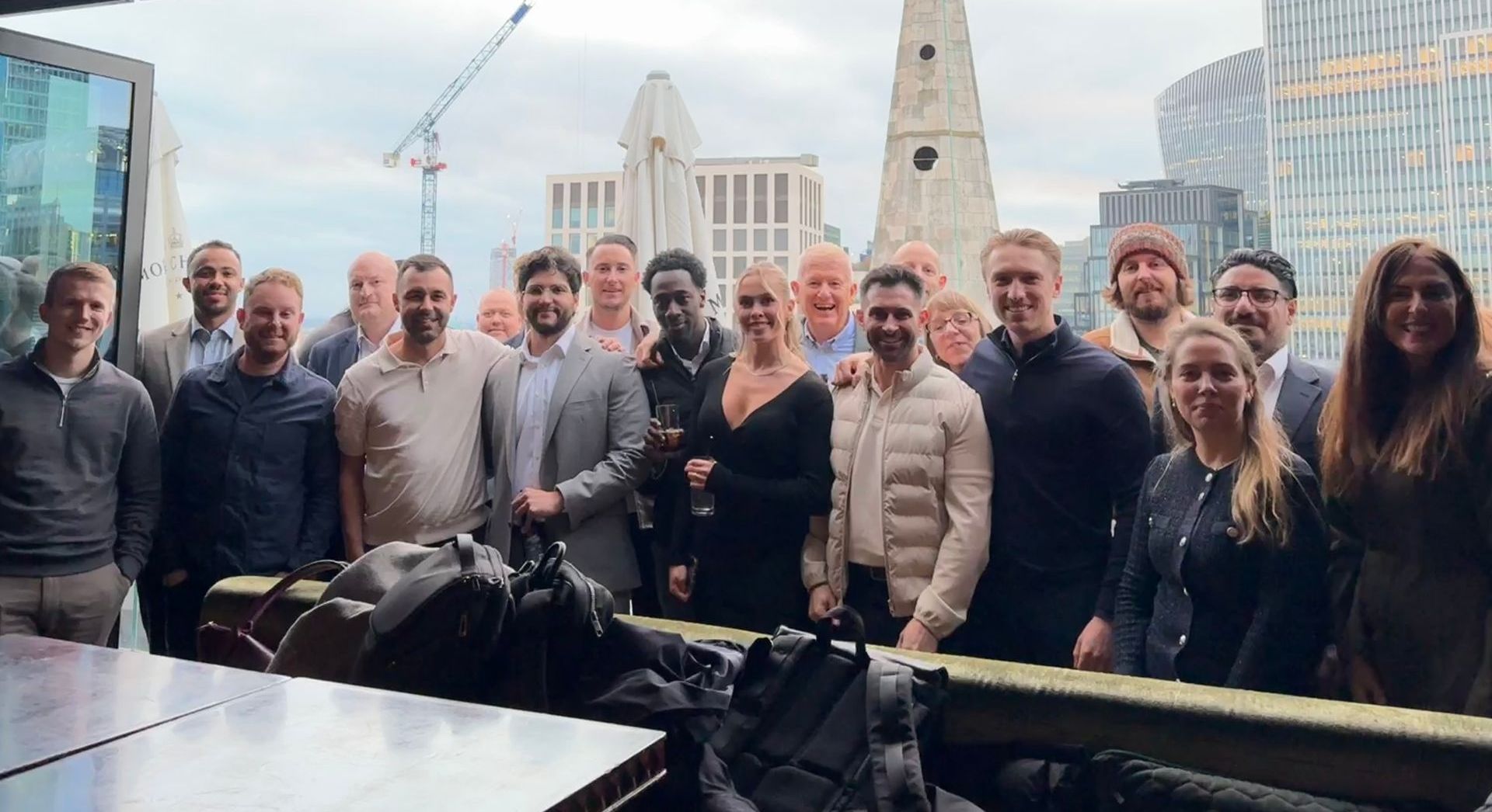 A group of people are posing for a picture on a balcony.