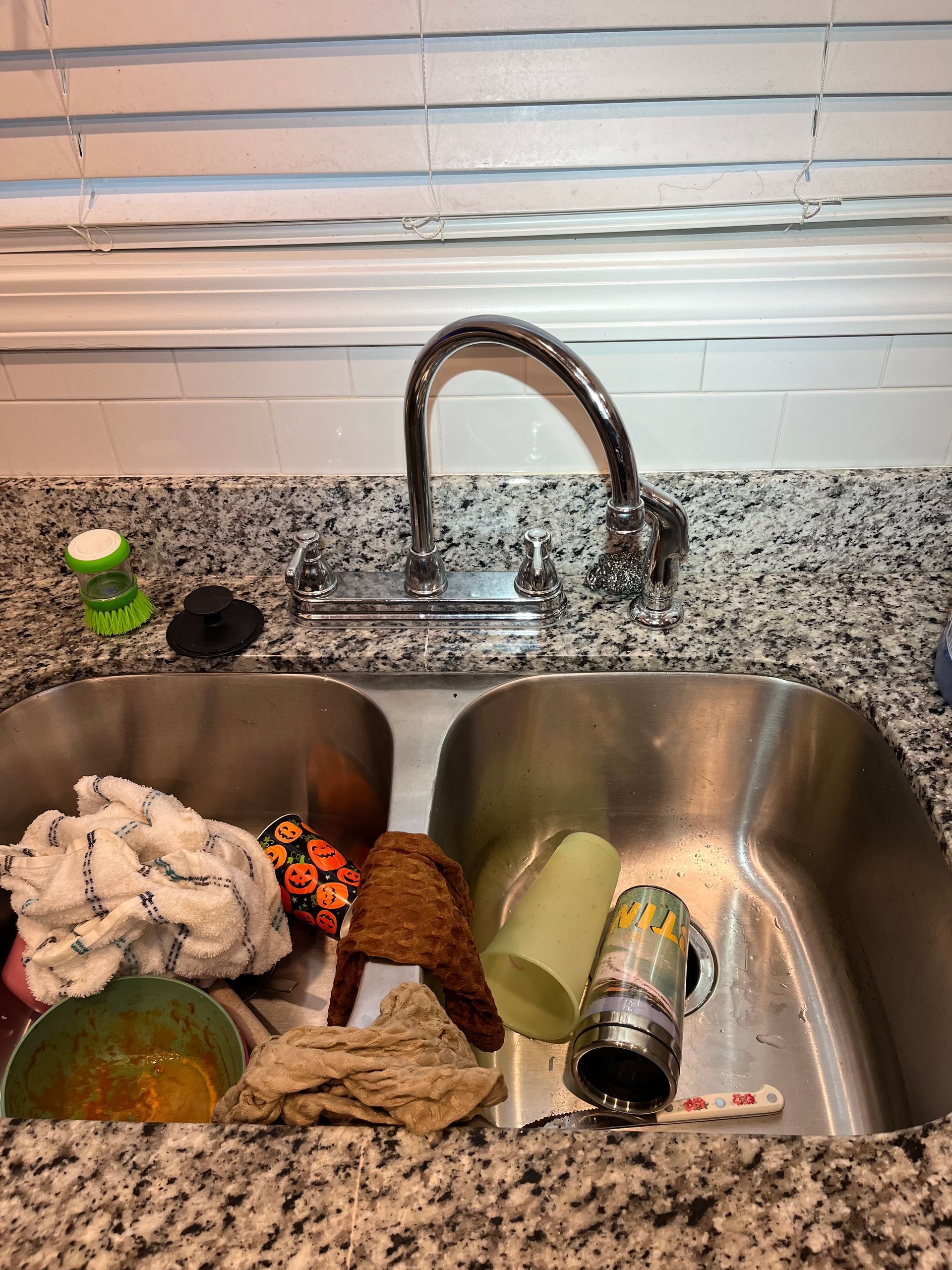 A kitchen sink with a lot of dirty dishes in it