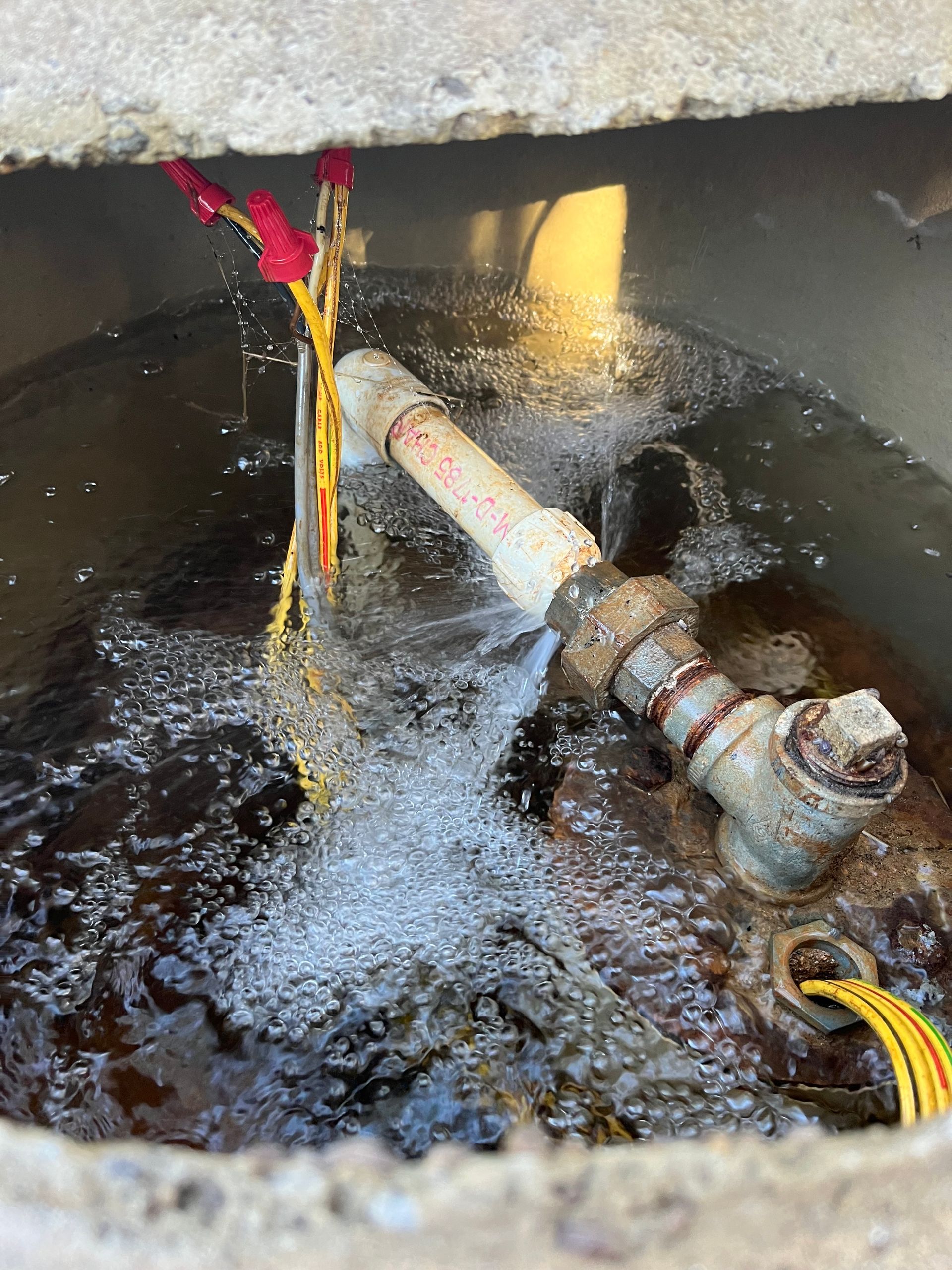 A pipe is coming out of a hole in the ground.