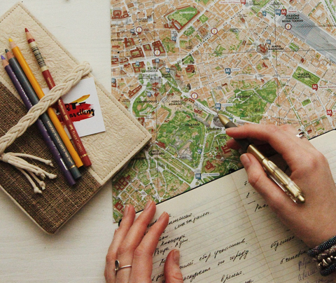 A traveller looks over a map and makes notes of where she'd like to go