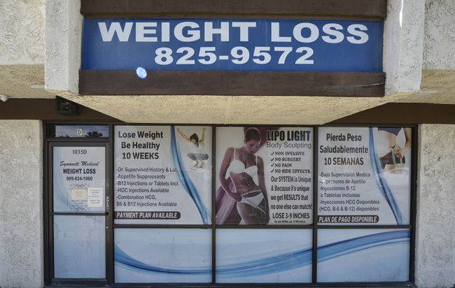 A building with a sign that says weight loss on it