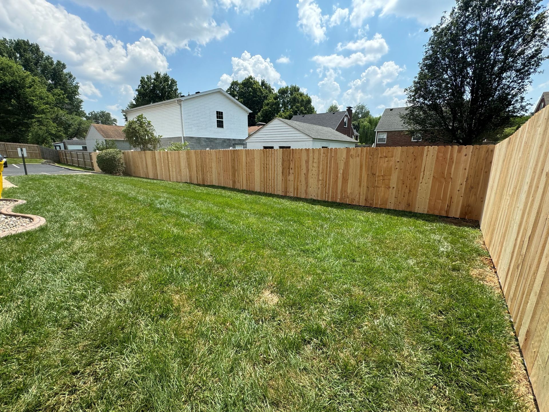 Wooden Fence Surrounds Green Lawn — Louisville, KY — Shatkoff Fencing