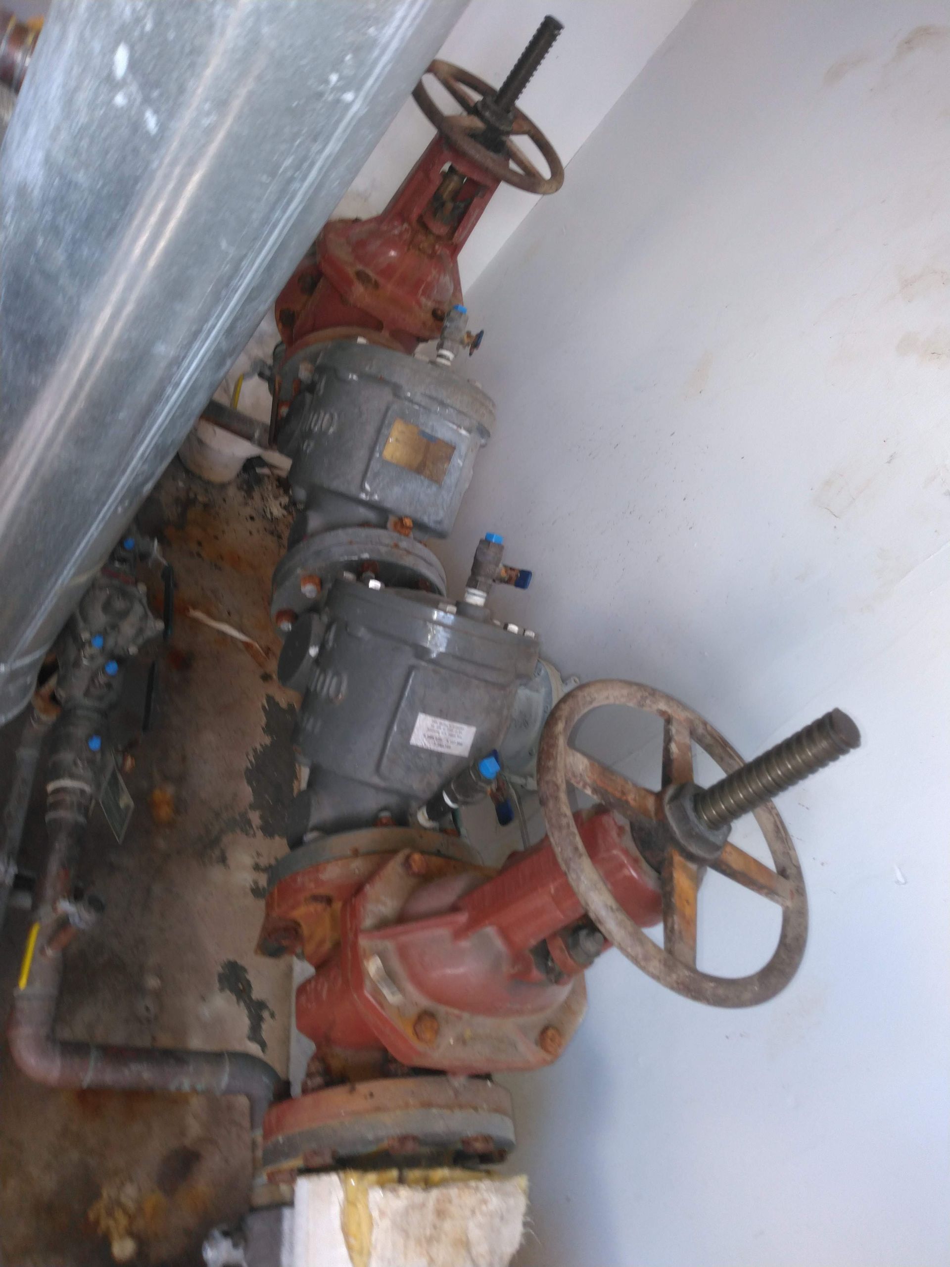 A bunch of valves with steering wheels on them