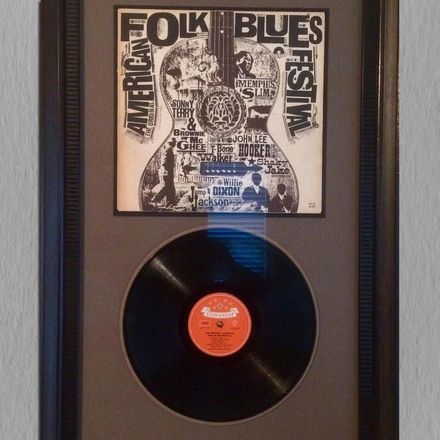 A record in a frame that says folk blues festival