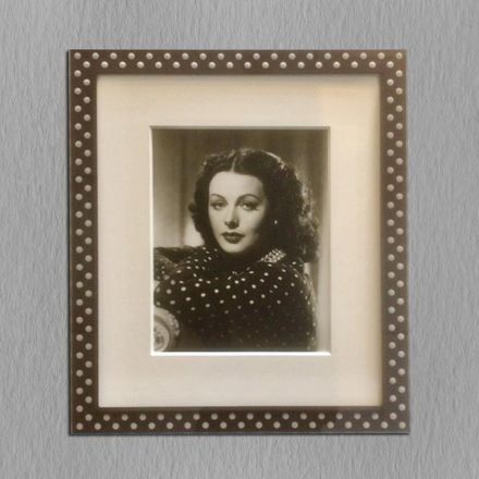 A black and white photo of a woman in a polka dot dress