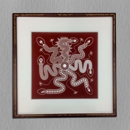 A framed picture of snakes on a red background