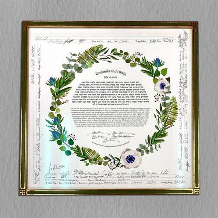 A framed piece of paper with a wreath of leaves and flowers on it