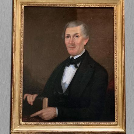 A framed portrait of a man in a tuxedo