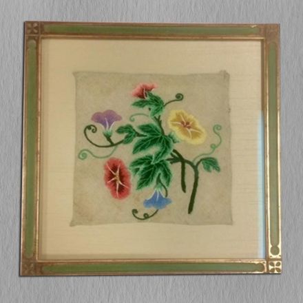 A picture of flowers in a gold frame