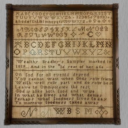 A framed piece of paper with the alphabet on it