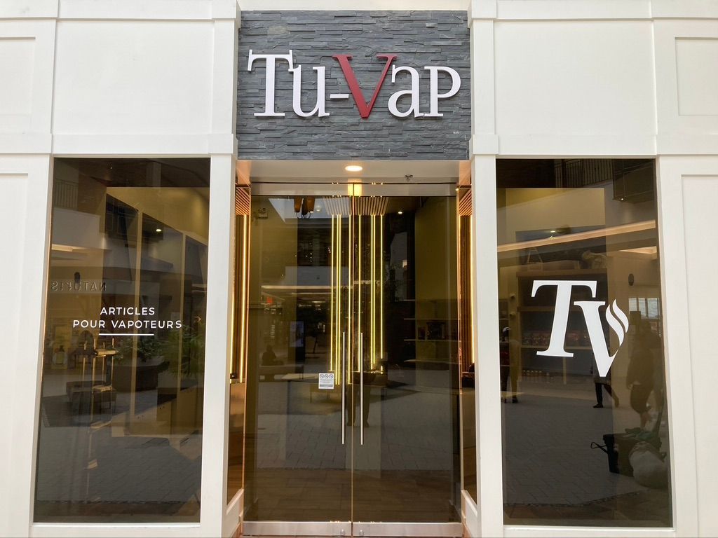 Un bâtiment avec un panneau indiquant « tu-vap » dessus