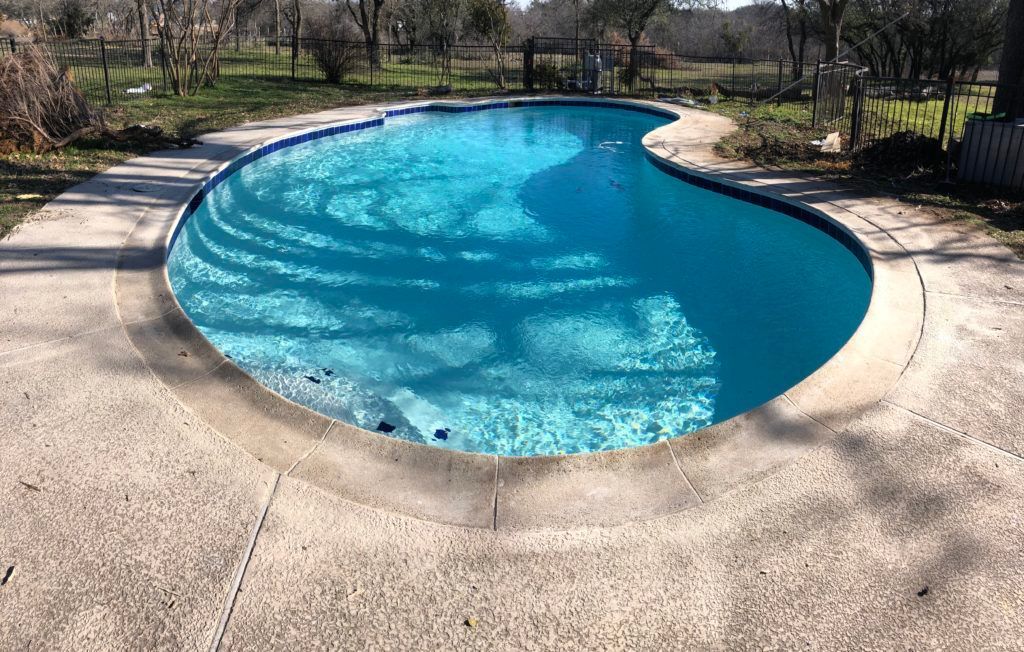 A large swimming pool with stairs leading to it