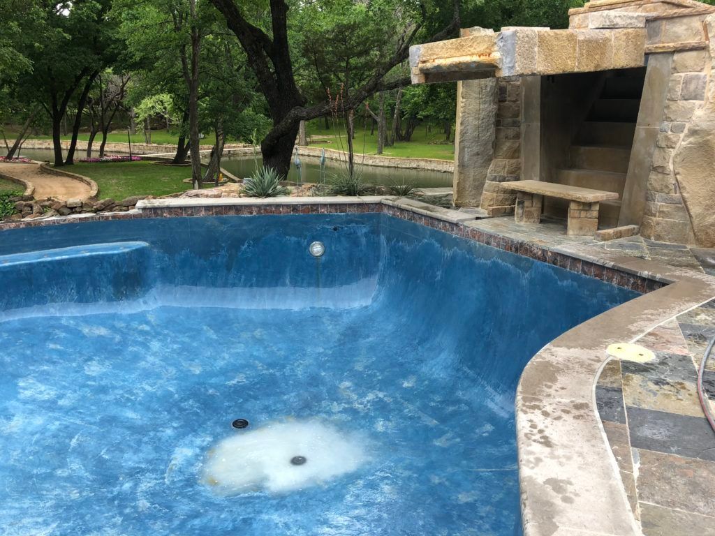 A large swimming pool with a waterfall in the background.
