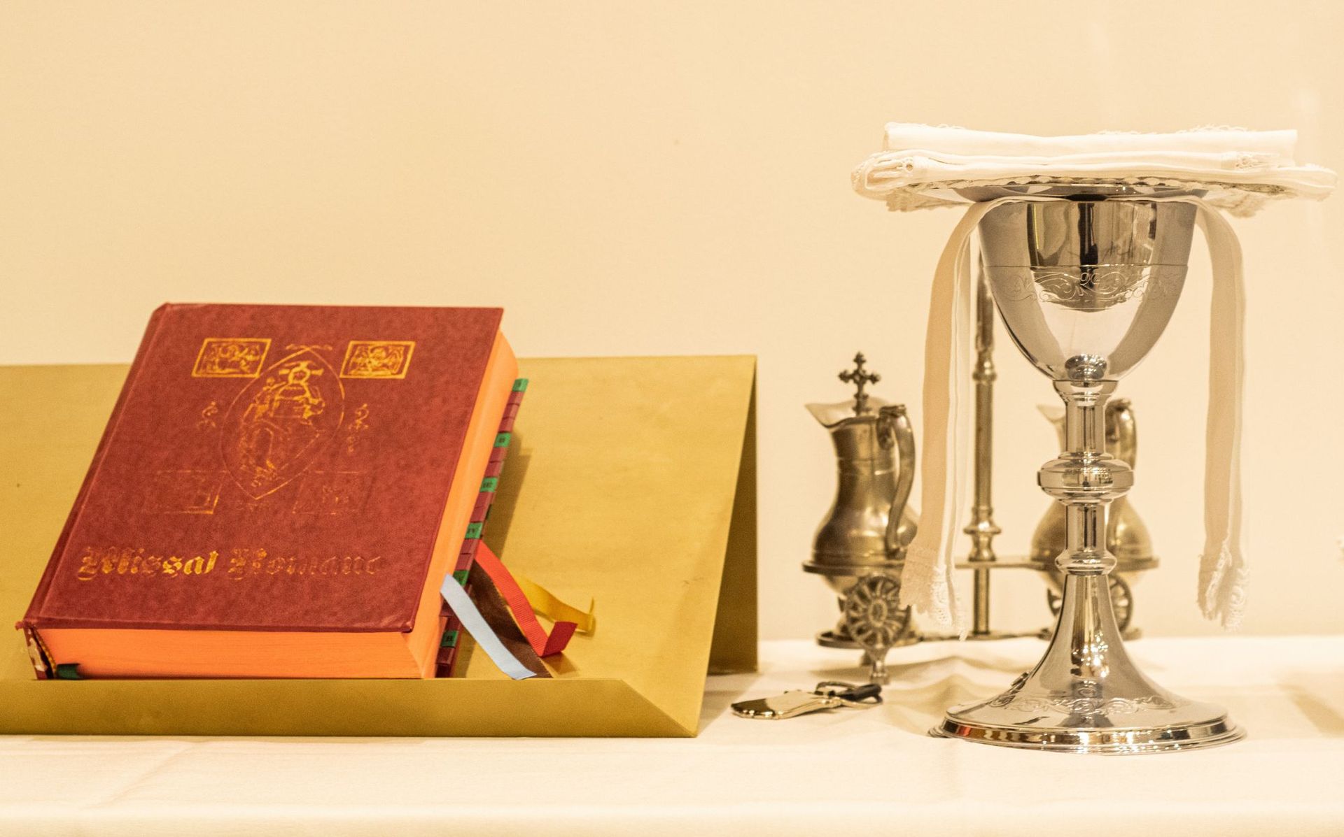 Picture of chalice and missal on an altar.