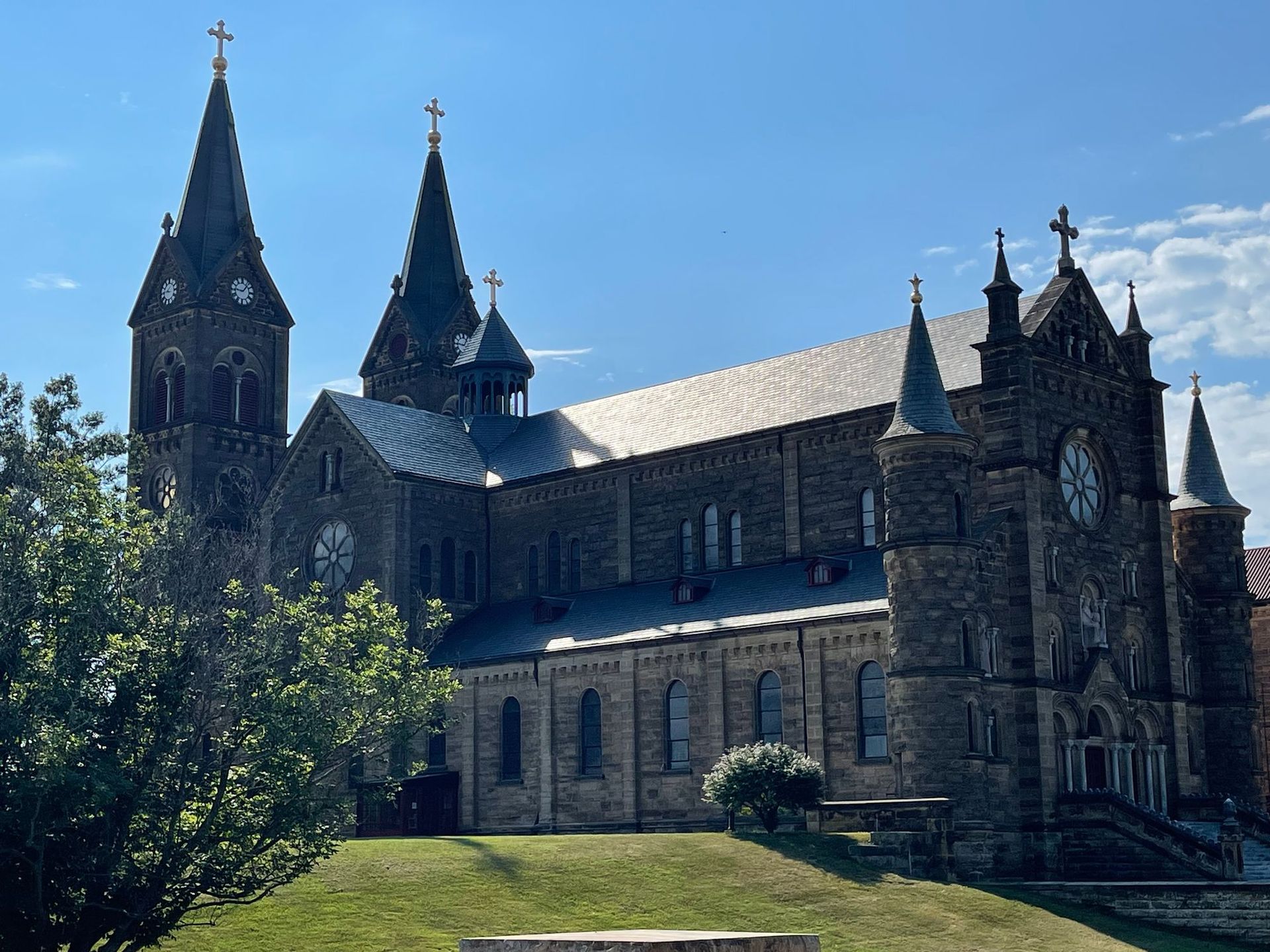 Stone church with multiple spires against a blue sky.