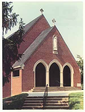 A brick church with a cross on top of it