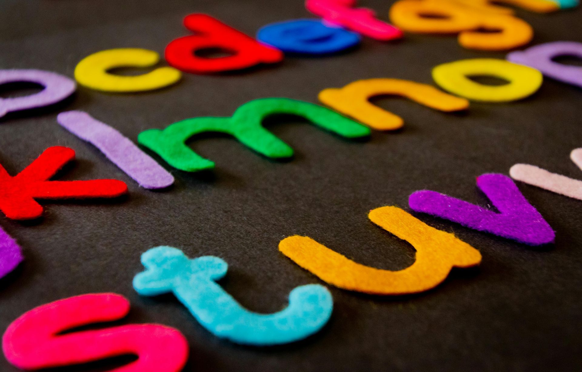 The letters abcdefghijklmnopqrstuvwxyz are lined up on a black surface