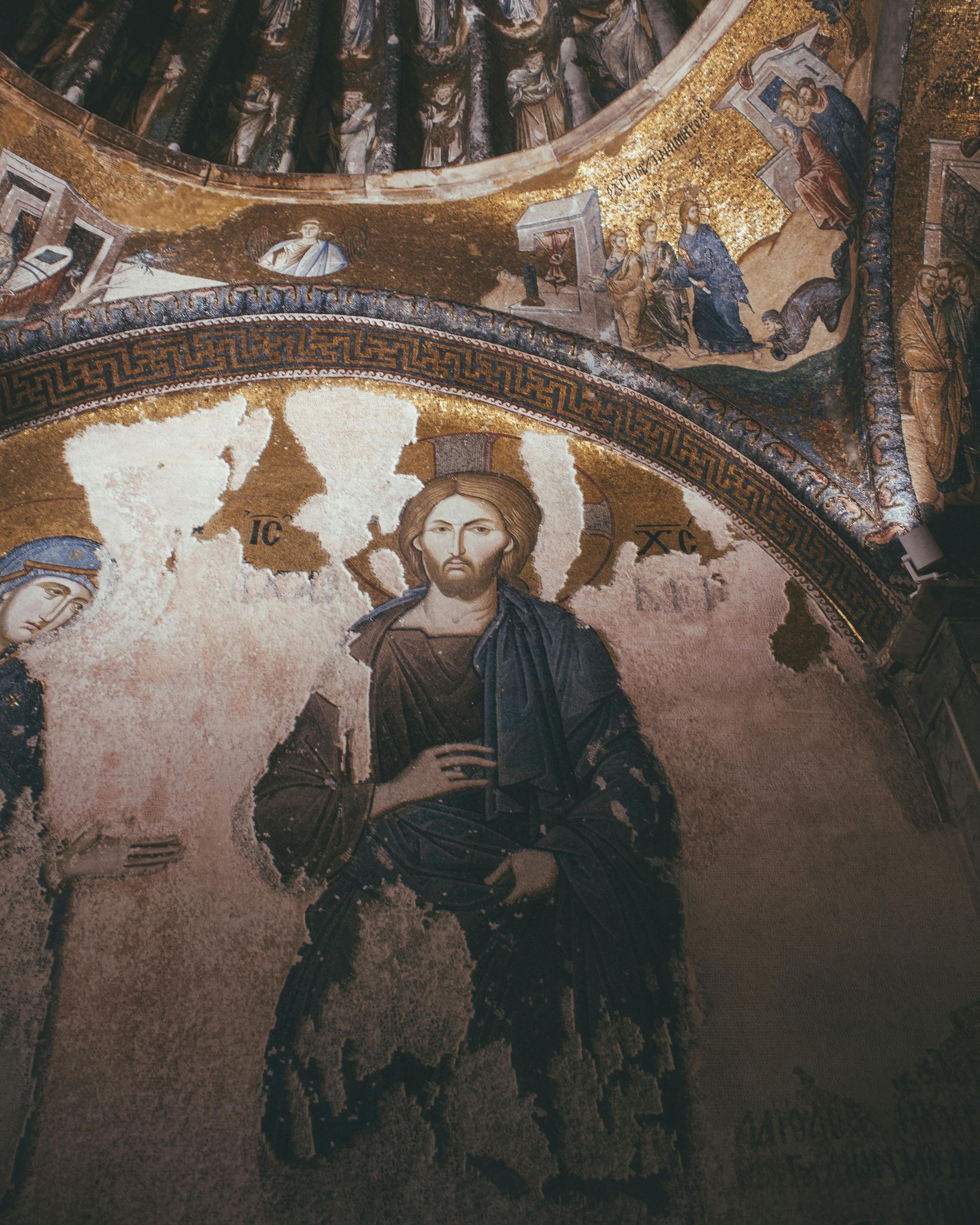 A painting of jesus in a blue robe with a crown of thorns on his head