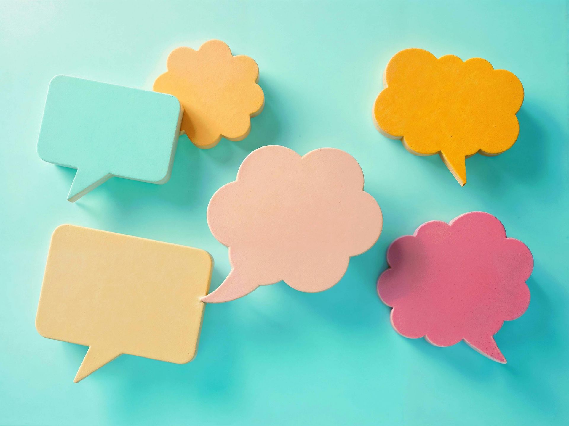 Five colorful speech bubbles on a turquoise background