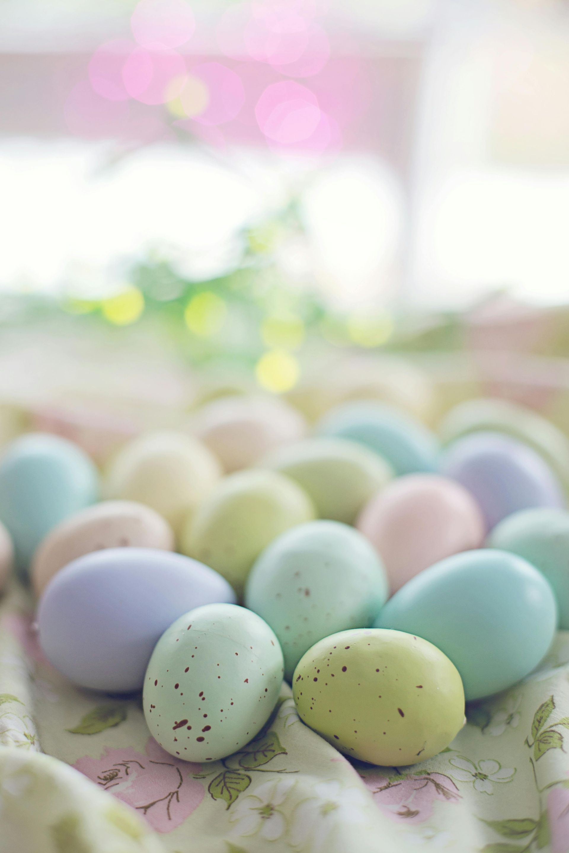 A bunch of colorful easter eggs are sitting on a table.