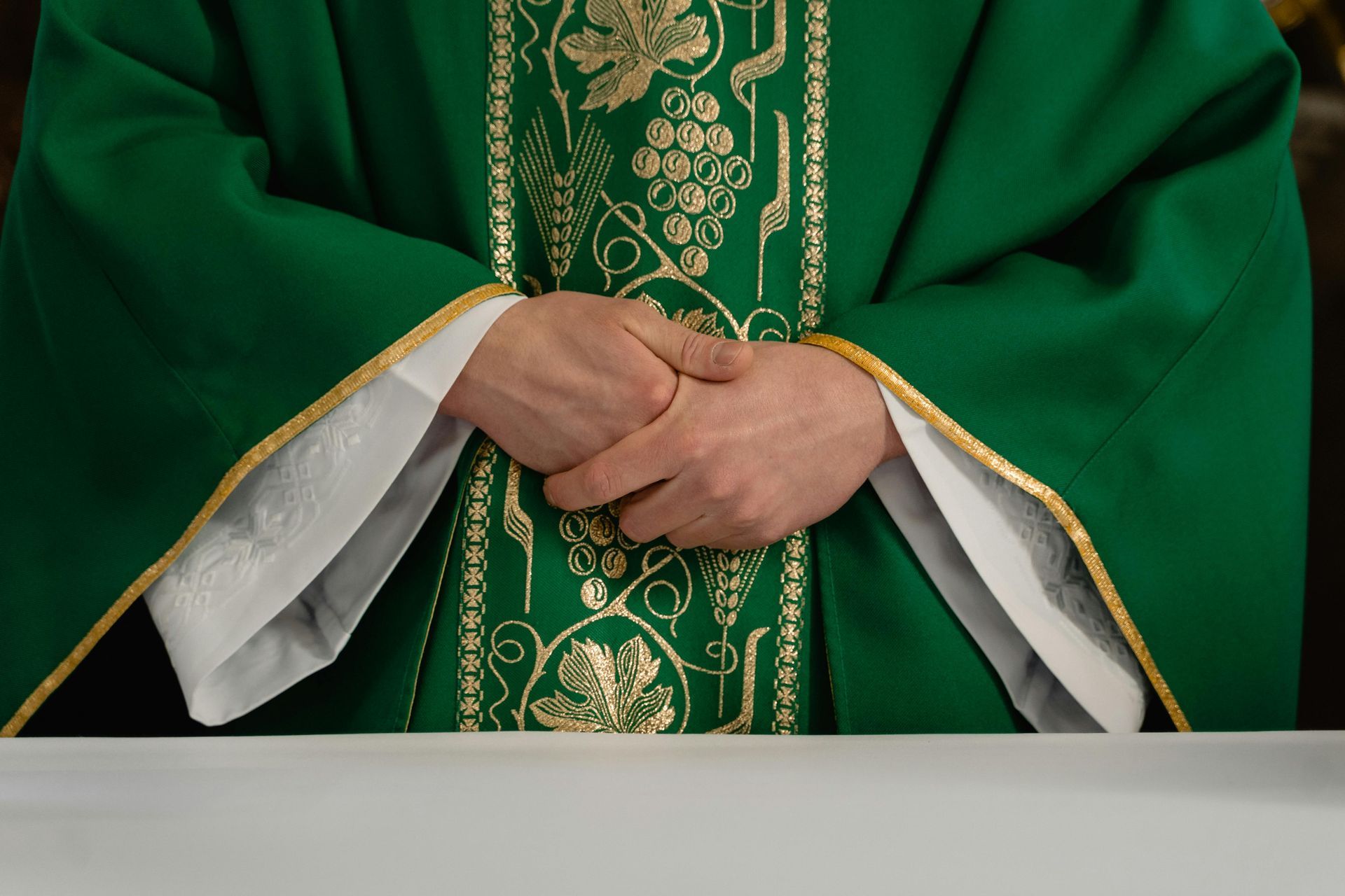 Priest in green robe