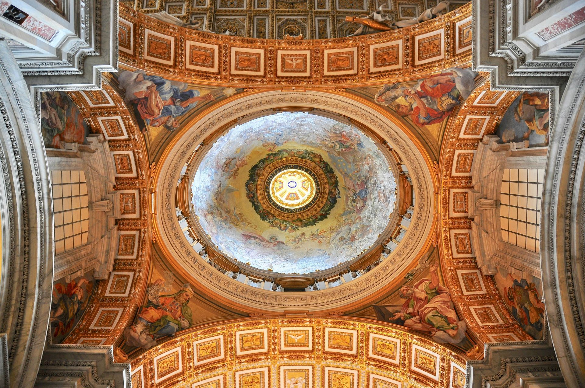 Looking up at the ceiling of a church with a dome