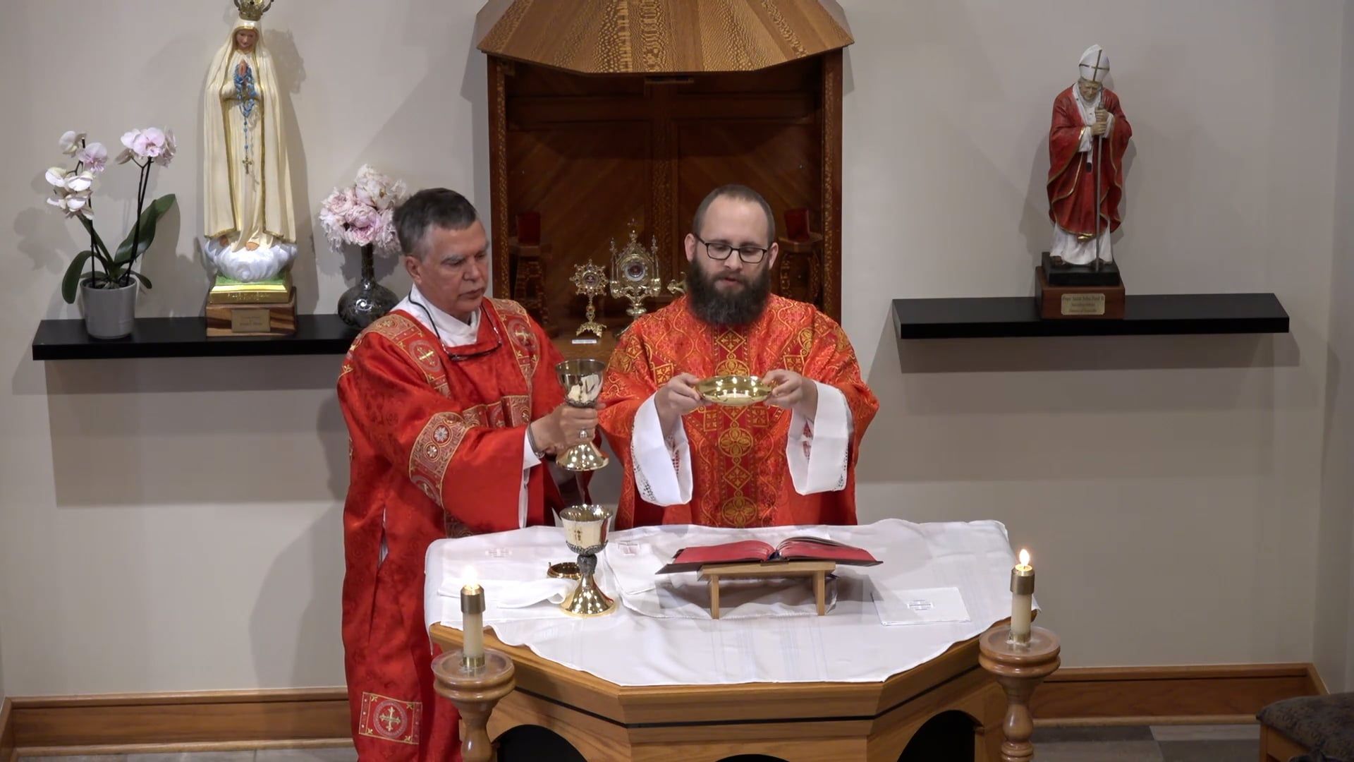 Two priests are celebrating a mass in a church.
