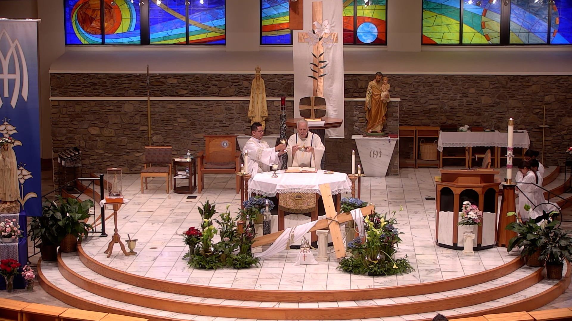 A church with a stained glass window behind the altar
