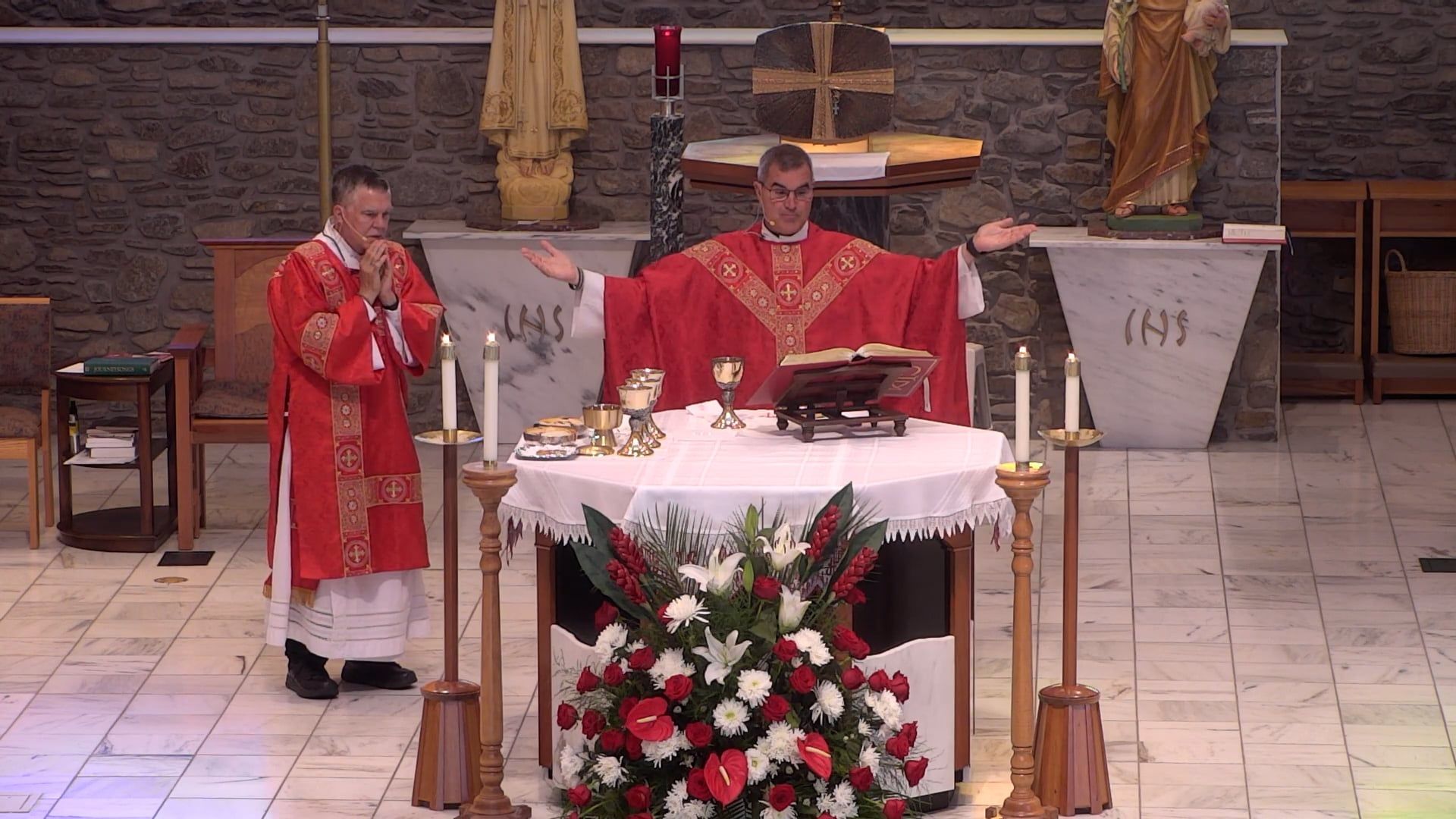 Fr. Pete and Deacon Leon are standing in front of an altar in a church.